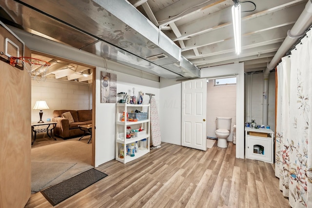 5046 Rolling Rock Ct, Columbus, OH 43229 - below grade area featuring wood finished floors and concrete block wall