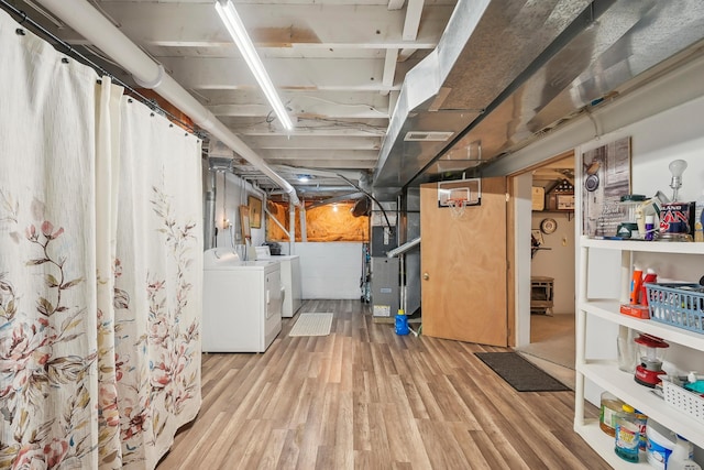 5046 Rolling Rock Ct, Columbus, OH 43229 - unfinished basement with separate washer and dryer, light wood-style flooring, and heating unit