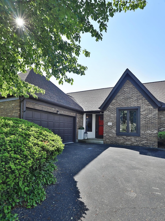7775 Pembrook Dr, Reynoldsburg, OH 43068 - view of front facade featuring brick siding, a shingled roof, and an attached garage