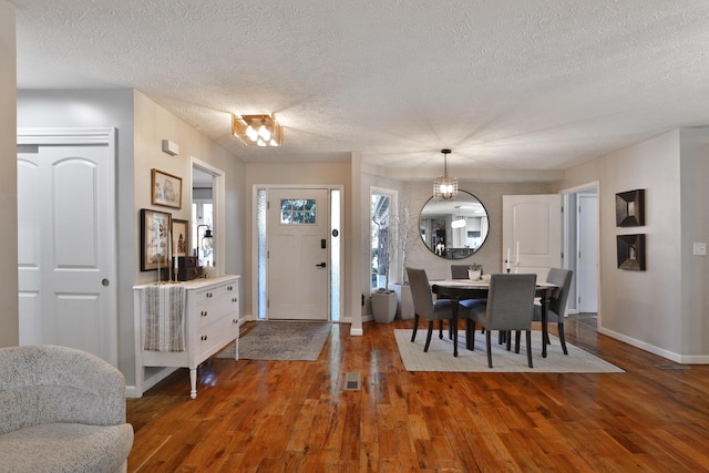 7775 Pembrook Dr, Reynoldsburg, OH 43068 - entrance foyer featuring baseboards, wood finished floors, and a textured ceiling