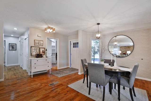 7775 Pembrook Dr, Reynoldsburg, OH 43068 - dining room with a chandelier, baseboards, and wood finished floors