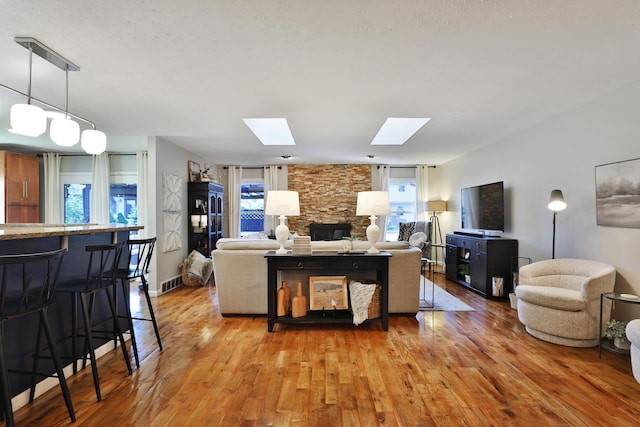 7775 Pembrook Dr, Reynoldsburg, OH 43068 - living room with a skylight, wood finished floors, and a fireplace