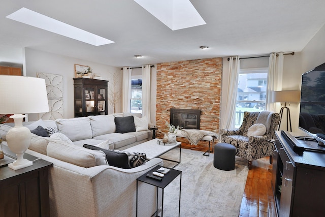 7775 Pembrook Dr, Reynoldsburg, OH 43068 - living room featuring a skylight, hardwood / wood-style flooring, and a stone fireplace