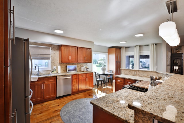 7775 Pembrook Dr, Reynoldsburg, OH 43068 - kitchen featuring stainless steel appliances, a sink, brown cabinets, light wood-style floors, and recessed lighting