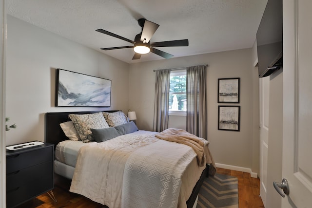 7775 Pembrook Dr, Reynoldsburg, OH 43068 - bedroom with dark wood finished floors, baseboards, a ceiling fan, and a textured ceiling