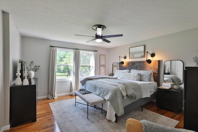 7775 Pembrook Dr, Reynoldsburg, OH 43068 - bedroom featuring wood finished floors, baseboards, a ceiling fan, and a textured ceiling
