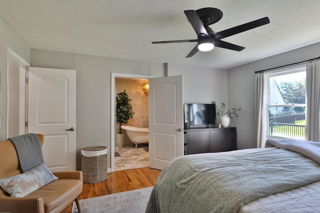 7775 Pembrook Dr, Reynoldsburg, OH 43068 - bedroom featuring wood finished floors, a textured ceiling, a ceiling fan, and ensuite bath