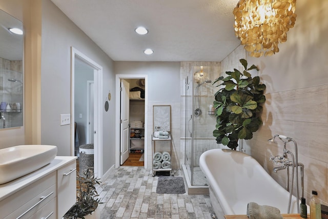 7775 Pembrook Dr, Reynoldsburg, OH 43068 - full bathroom featuring a shower stall, vanity, a freestanding bath, wood finished floors, and recessed lighting