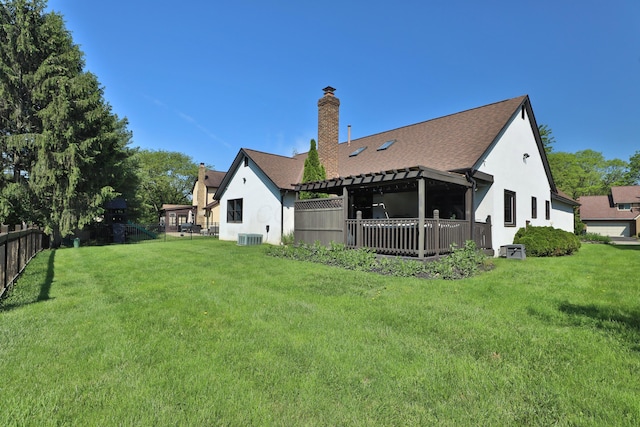 7775 Pembrook Dr, Reynoldsburg, OH 43068 - back of house with stucco siding, central AC unit, a chimney, and a shingled roof
