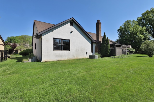7775 Pembrook Dr, Reynoldsburg, OH 43068 - back of property with a chimney, stucco siding, a yard, and roof with shingles