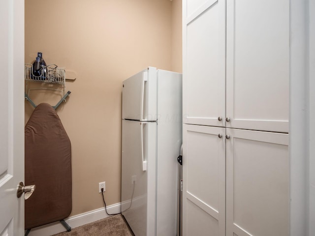 11465 Canby Ct, Plain City, OH 43064 - kitchen with freestanding refrigerator, white cabinets, baseboards, and carpet flooring