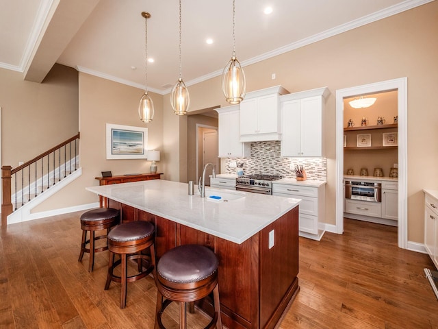 11465 Canby Ct, Plain City, OH 43064 - kitchen with a sink, stainless steel appliances, dark wood finished floors, a kitchen island with sink, and tasteful backsplash