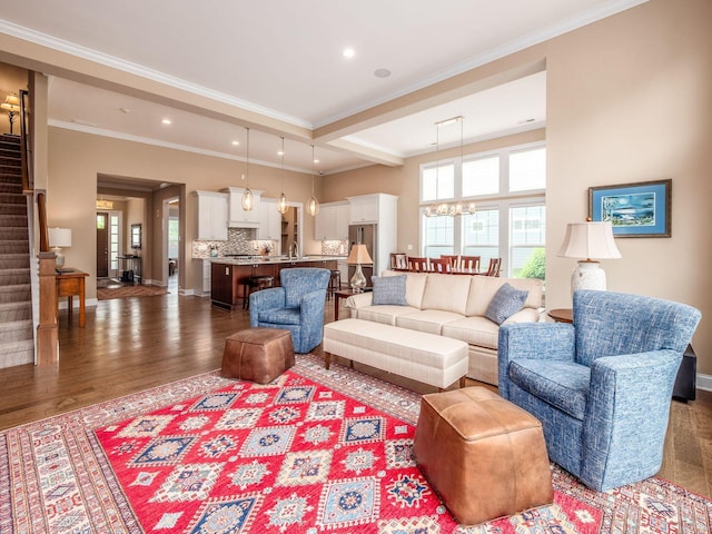 11465 Canby Ct, Plain City, OH 43064 - living room featuring stairs, wood finished floors, a chandelier, ornamental molding, and recessed lighting