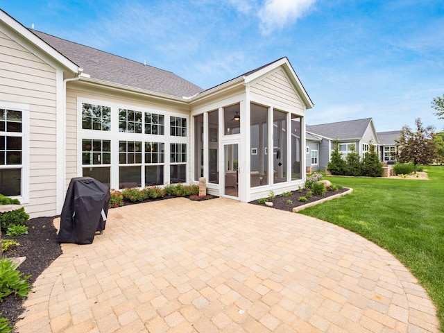 11465 Canby Ct, Plain City, OH 43064 - back of property featuring a sunroom, a patio area, a yard, and a shingled roof