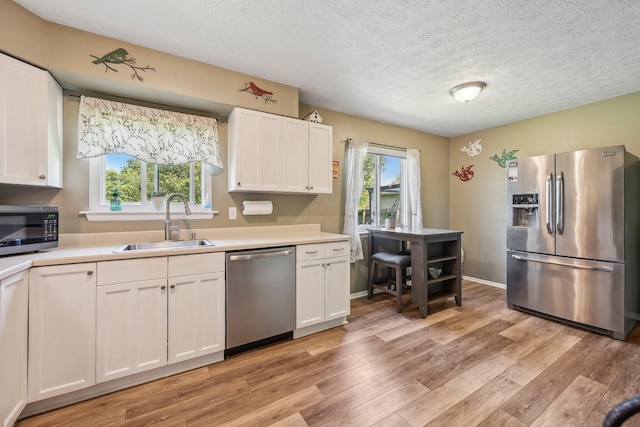 268 Southwood Rd, West Jefferson, OH 43162 - kitchen with appliances with stainless steel finishes, a sink, light countertops, white cabinetry, and a textured ceiling