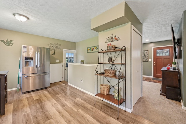 268 Southwood Rd, West Jefferson, OH 43162 - kitchen featuring stainless steel fridge with ice dispenser, a textured ceiling, light wood-type flooring, and baseboards