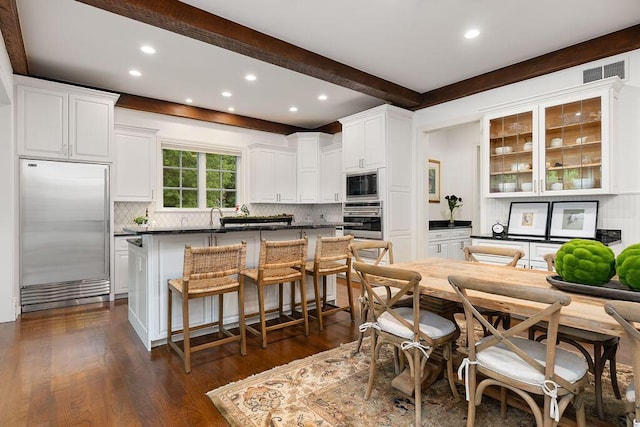 2989 Old Path Rd, Blacklick, OH 43004 - kitchen featuring built in appliances, recessed lighting, dark countertops, tasteful backsplash, and a breakfast bar