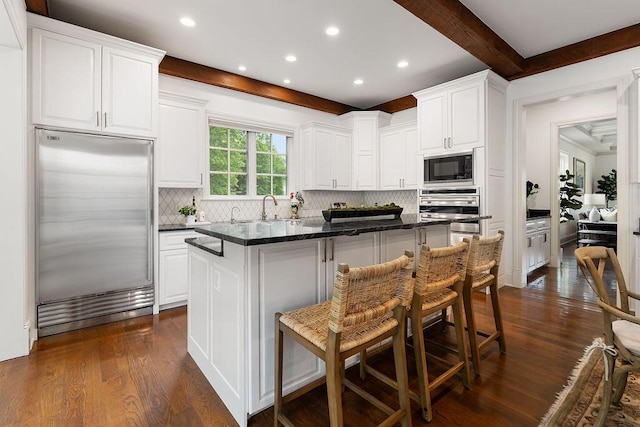 2989 Old Path Rd, Blacklick, OH 43004 - kitchen featuring built in appliances, a kitchen island, dark wood-style flooring, recessed lighting, and white cabinetry