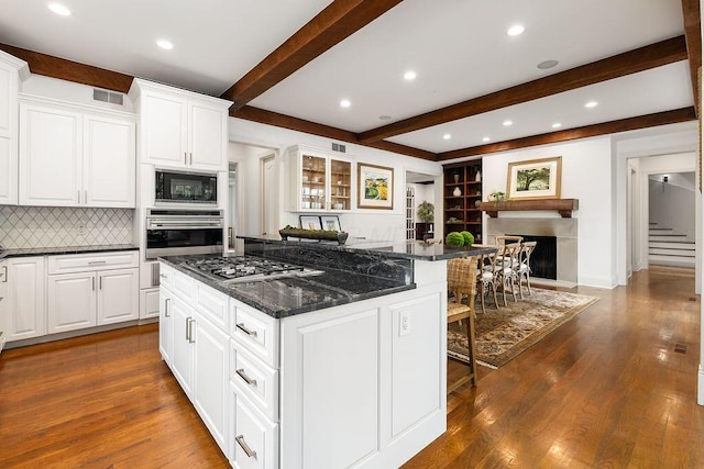 2989 Old Path Rd, Blacklick, OH 43004 - kitchen featuring stainless steel appliances, a center island, beamed ceiling, a breakfast bar, and tasteful backsplash