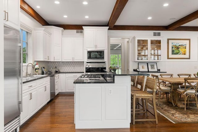 2989 Old Path Rd, Blacklick, OH 43004 - kitchen featuring built in appliances, a sink, dark wood-style flooring, dark countertops, and beamed ceiling