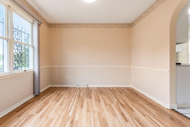 5946 Lisa St, Columbus, OH 43231 - spare room featuring arched walkways and light wood-style flooring