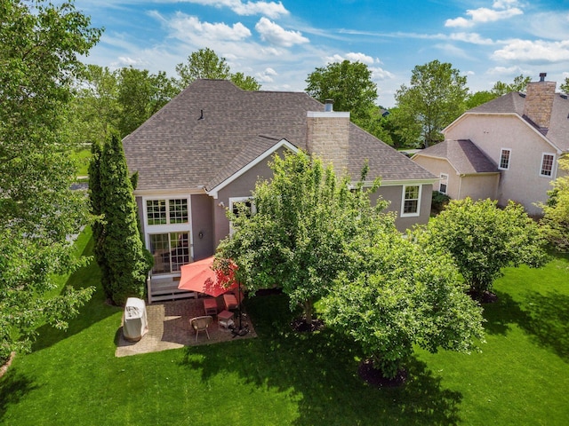 6628 Dalmore Ln, Dublin, OH 43016 - back of property with roof with shingles, a yard, a chimney, and a wooden deck