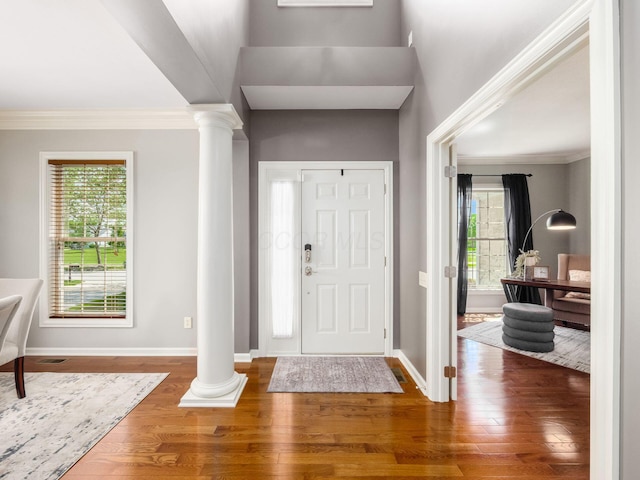 6628 Dalmore Ln, Dublin, OH 43016 - foyer featuring decorative columns, wood finished floors, baseboards, and crown molding