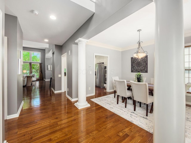6628 Dalmore Ln, Dublin, OH 43016 - dining room featuring decorative columns, dark wood-type flooring, crown molding, baseboards, and recessed lighting