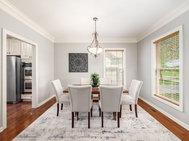 6628 Dalmore Ln, Dublin, OH 43016 - dining area featuring crown molding, dark wood-style flooring, and baseboards