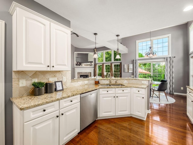 6628 Dalmore Ln, Dublin, OH 43016 - kitchen with stainless steel dishwasher, a sink, dark wood-type flooring, and a fireplace