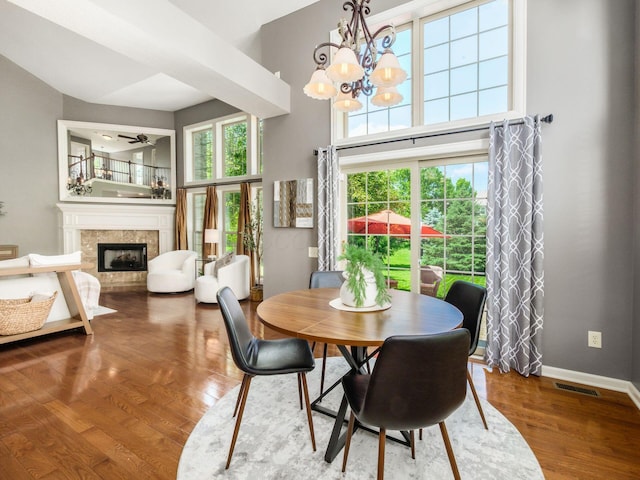 6628 Dalmore Ln, Dublin, OH 43016 - dining space featuring a towering ceiling, ceiling fan, healthy amount of natural light, a fireplace, and a chandelier