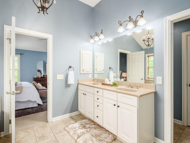 6628 Dalmore Ln, Dublin, OH 43016 - ensuite bathroom with a chandelier, double vanity, tile patterned floors, baseboards, and vaulted ceiling