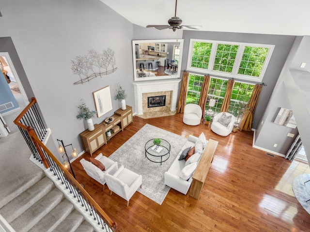 6628 Dalmore Ln, Dublin, OH 43016 - living area with wood finished floors, ceiling fan, a fireplace, stairway, and lofted ceiling