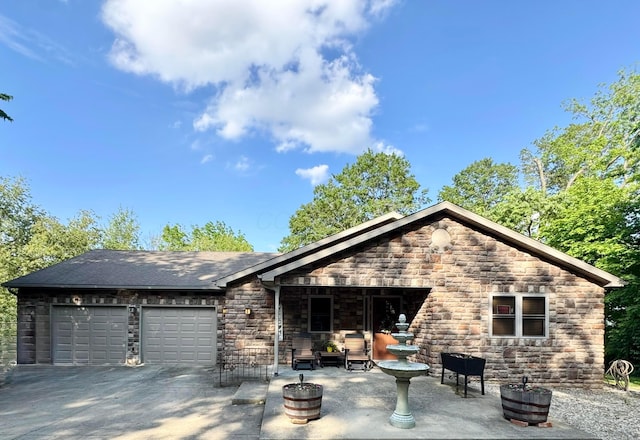 216 Woodland Way, Chillicothe, OH 45601 - view of front facade with stone siding, an attached garage, and concrete driveway