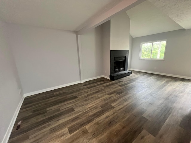 139 Corbins Mill Dr, Dublin, OH 43017 - unfurnished living room featuring a fireplace with raised hearth, dark wood-type flooring, baseboards, and lofted ceiling