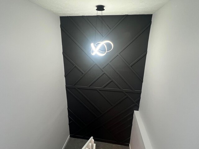 139 Corbins Mill Dr, Dublin, OH 43017 - stairway with a decorative wall, carpet floors, and a chandelier