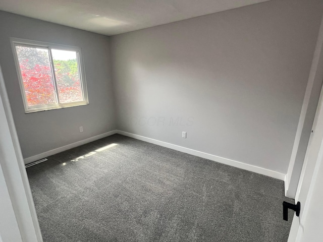 139 Corbins Mill Dr, Dublin, OH 43017 - spare room featuring dark colored carpet and baseboards