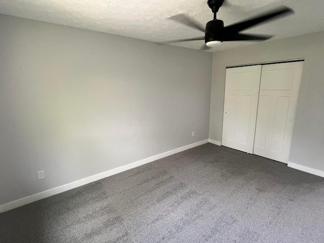 139 Corbins Mill Dr, Dublin, OH 43017 - unfurnished bedroom featuring dark colored carpet, baseboards, a textured ceiling, a closet, and a ceiling fan