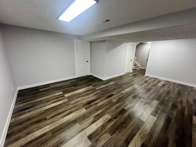 139 Corbins Mill Dr, Dublin, OH 43017 - finished basement with baseboards, dark wood-style flooring, and stairway