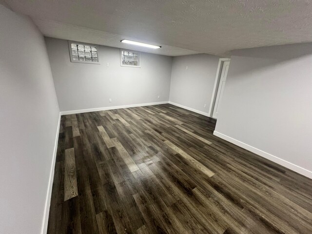 139 Corbins Mill Dr, Dublin, OH 43017 - below grade area featuring dark wood-style floors, a textured ceiling, and baseboards