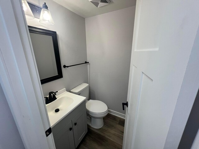 139 Corbins Mill Dr, Dublin, OH 43017 - half bath featuring toilet, wood finished floors, vanity, and baseboards