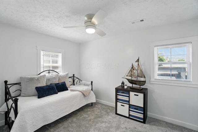 446 E Beck St, Columbus, OH 43206 - bedroom featuring multiple windows, carpet floors, baseboards, a textured ceiling, and ceiling fan