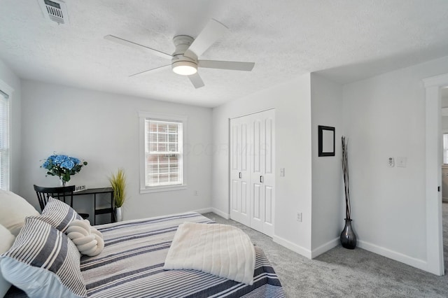 446 E Beck St, Columbus, OH 43206 - bedroom featuring a closet, carpet, baseboards, a textured ceiling, and ceiling fan