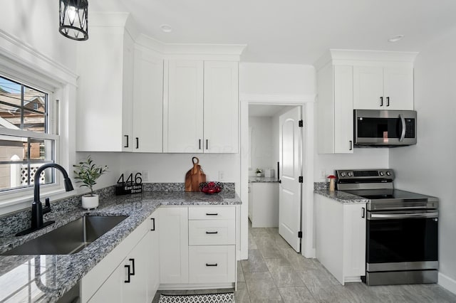 446 E Beck St, Columbus, OH 43206 - kitchen featuring appliances with stainless steel finishes, a sink, white cabinets, and stone countertops