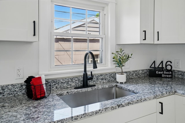 446 E Beck St, Columbus, OH 43206 - kitchen view of a sink, white cabinets, and light stone counters