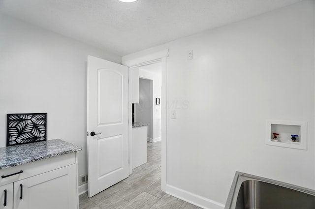 446 E Beck St, Columbus, OH 43206 - laundry area with hookup for a washing machine, cabinet space, and baseboards