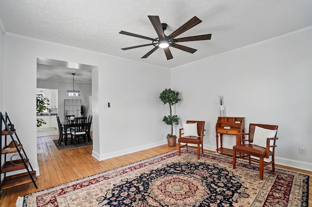 446 E Beck St, Columbus, OH 43206 - living area with hardwood / wood-style floors, ceiling fan, baseboards, and crown molding