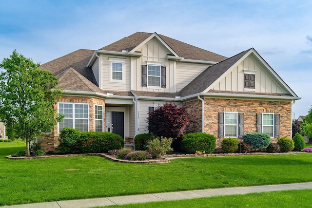 craftsman house featuring board and batten siding, a front yard, and stone siding