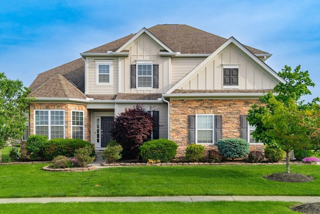 view of front facade featuring board and batten siding, stone siding, and a front lawn