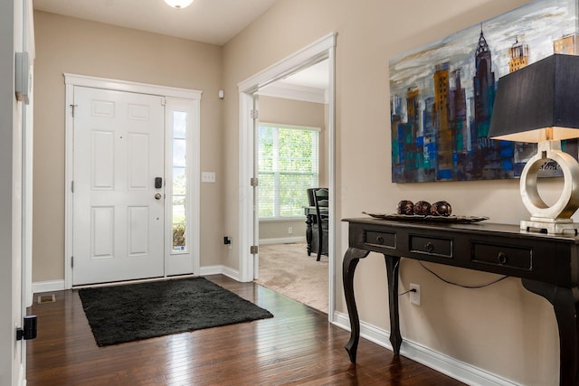 entryway with dark wood finished floors and baseboards